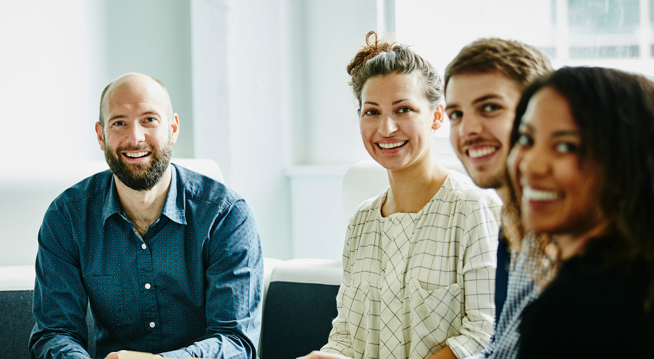 Business team smiling during a meeting.